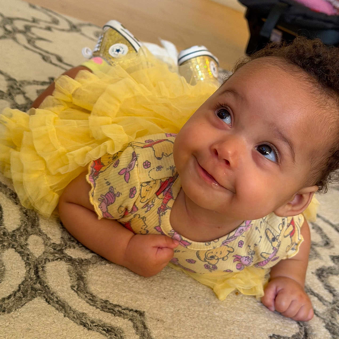 Venera joined the competition — help win amazing prizes! baby, child, yellow_dress, tutu, smile, face, eyes, carpet, pattern, indoor, cute, curly_hair, sneakers, floor, infant, playful, person, toddler, happy, clothing