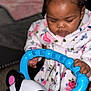 Gi Ariyae is registered to the contest to win money with this photo: toddler, child, toy, blue, panda, handle, robe, floral, indoor, concentration, baby, cute, hands, face, curly_hair, headband, play, young_child, person, closeup