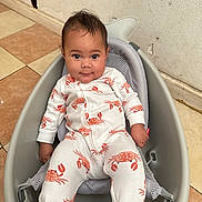 Zaileigh joined the competition — help win amazing prizes! baby, infant, onesie, crab_pattern, baby_seat, indoor, tiled_floor, wall, child, cute, relaxed, looking_at_camera, small_child, seat, mesh, gray, white_clothing, orange, playful_pattern, casual