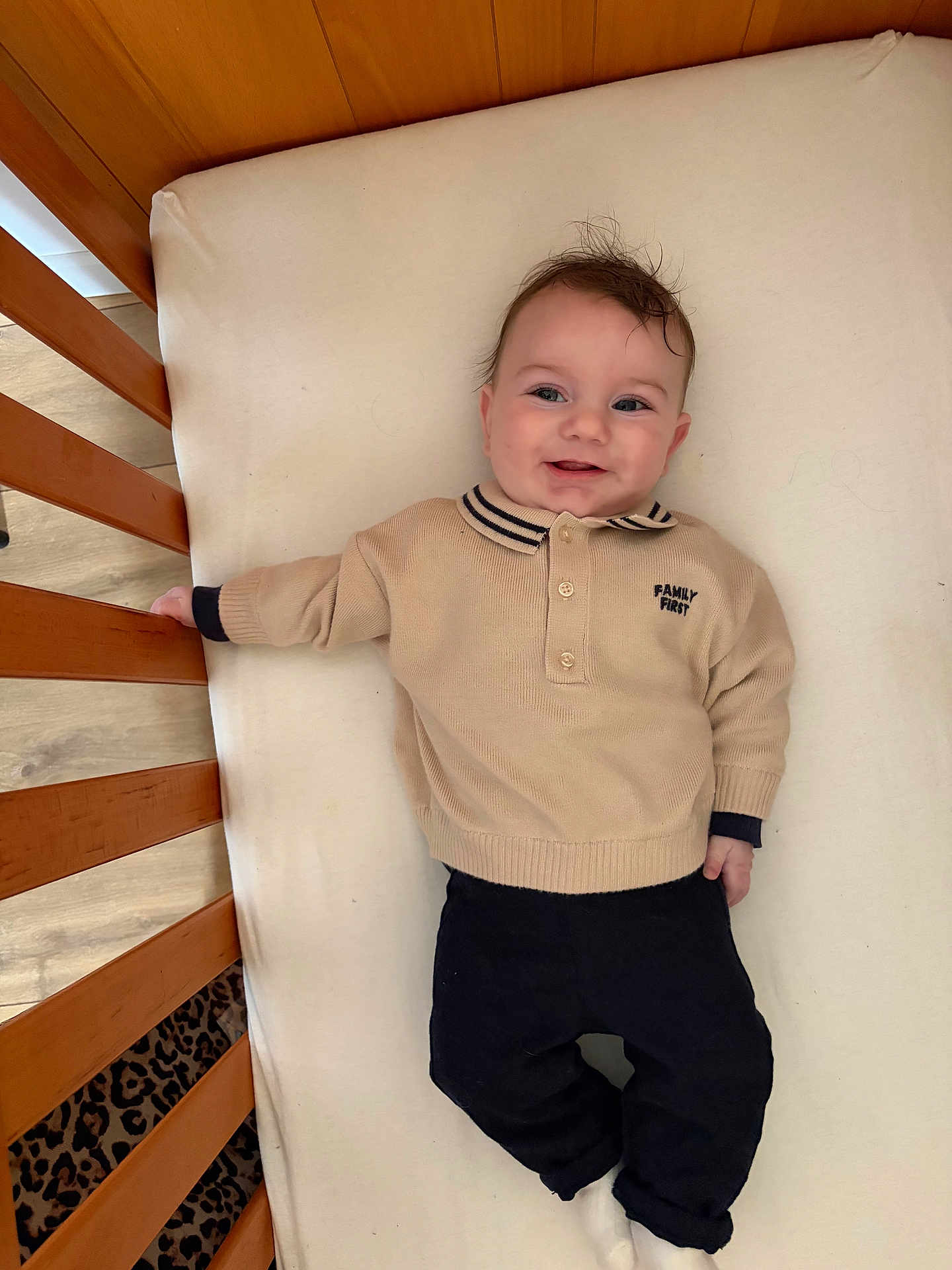 Lushenzo participe au concours pour gagner de l'argent avec cette photo : baby, infant, crib, mattress, sweater, collar, pants, socks, smile, happy, face, eyes, hair, hand, wooden_slats, portrait, indoor, bedding, cute, lying_down