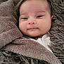 Nirina participe au concours pour gagner de l'argent avec cette photo : baby, blanket, brown, cozy, cute, face, fluffy, indoors, infant, laying_down, looking_at_camera, peaceful, portrait, smiling, snug, soft_texture, toddler, warm, wrapped, young_child