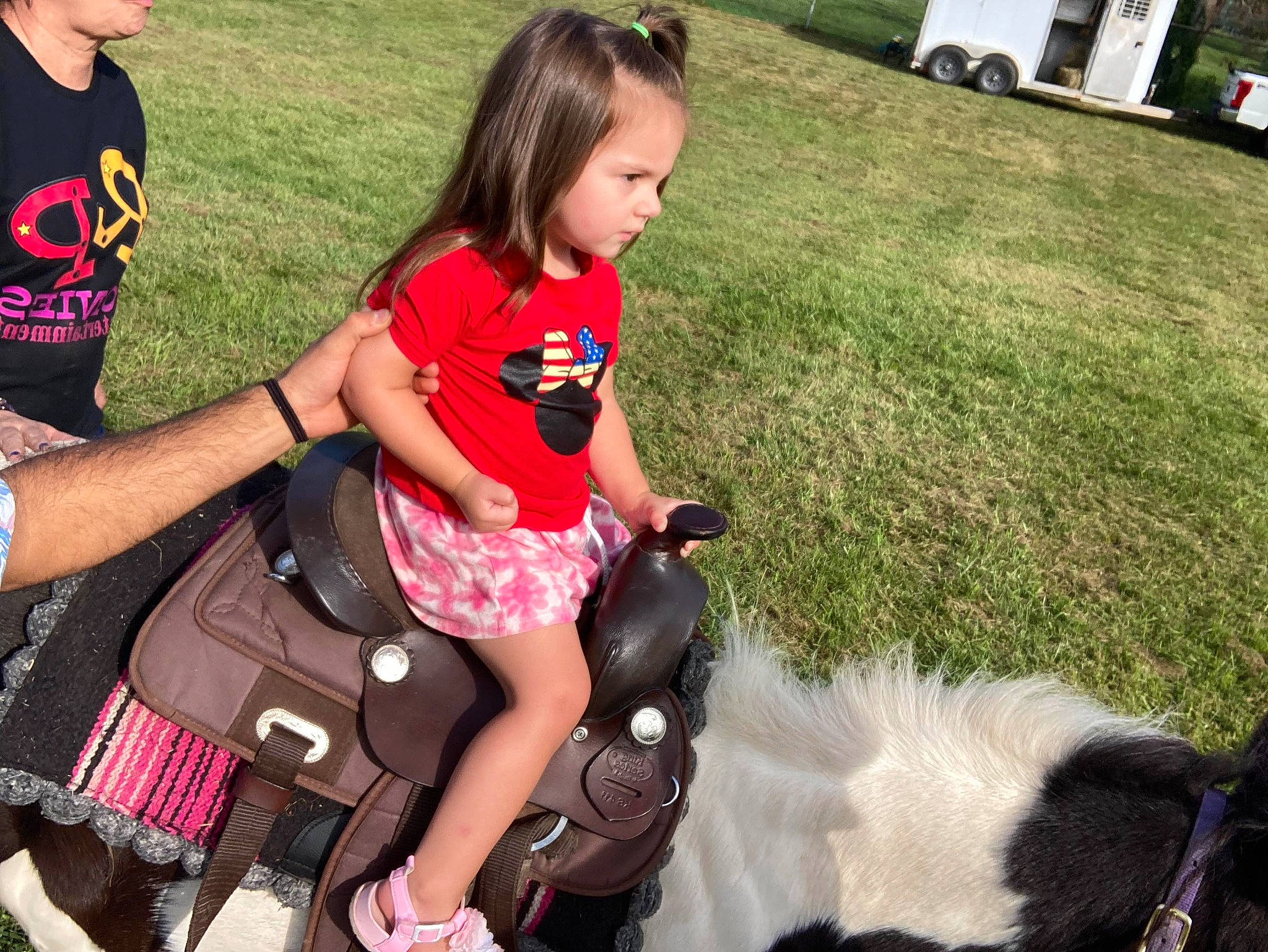 Anastasia is registered to the contest to win money with this photo: bridle, event, friendship, fun, grass, happy, lap, leg, leisure, pack_animal, person, plant, public_space, recreation, shorts, snapshot, t_shirt, thigh, toddler, vertebrate