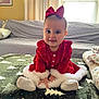 Genevieve is registered to the contest to win money with this photo: baby, blanket, bow, child, christmas_theme, cozy, curtains, cute, face, fur_trim, furniture, happy, holiday, indoors, person, red_dress, sitting, smile, soft_lighting, window