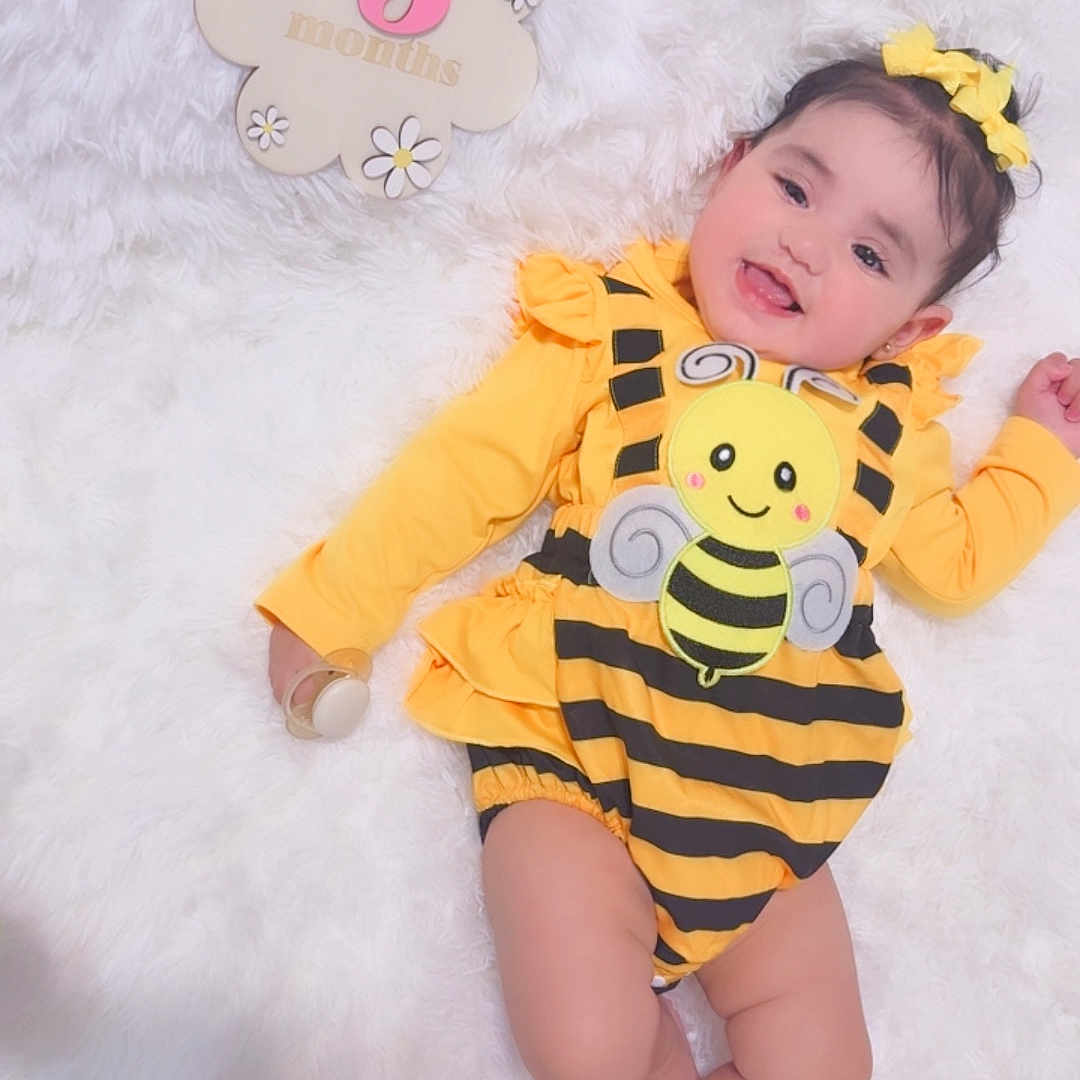 Janielys joined the competition — help win amazing prizes! baby, infant, smiling, yellow_clothing, bumblebee_outfit, headband, flower_sign, 5_months, lying_down, white_background, cute, child, happy, portrait, soft_texture, baby_girl, closeup, adorable, one_child, indoor