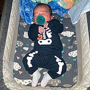 Miguel joined the competition — help win amazing prizes! baby, infant, sleeping, pacifier, crib, blanket, clothing, skeleton_outfit, sock, bed, baby_bedding, cute, child, soft, resting, indoors, person, newborn, comfort, sleep