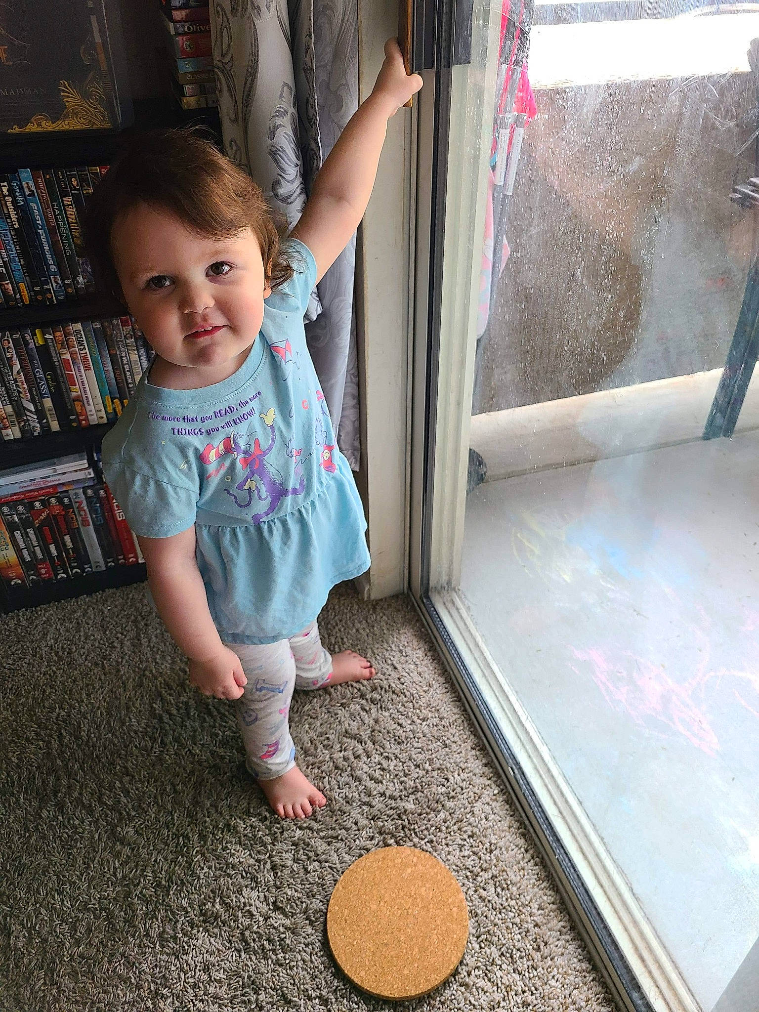 Raelynn is registered to the contest to win money with this photo: baby, baby_toddler_clothing, barefoot, bookcase, child, finger, floor, flooring, foot, fun, hand, human_body, human_leg, person, play, shelf, shelving, skin, smile, toddler