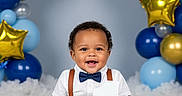 Joao Julian joined the competition — help win amazing prizes! baby, balloons, blue_balloons, bow_tie, boy, celebration, child, cute, fluffy_surface, gold_balloons, happy, indoor, number_one, portrait, silver_balloons, sitting, smiling, star_shaped_balloons, suspenders, white_shirt