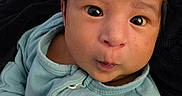 Ezekiel is registered to the contest to win money with this photo: baby, infant, face, eyes, hoodie, clothing, skin, expression, pout, child, cute, portrait, newborn, person, warm, soft, blanket, indoor, young, head