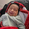 Ezekiel joined the competition — help win amazing prizes! baby, smiling, blanket, red, white, cozy, indoor, infant, clothing, person, portrait, cute, sleepy, warm, toddler, face, head, happy, resting, child