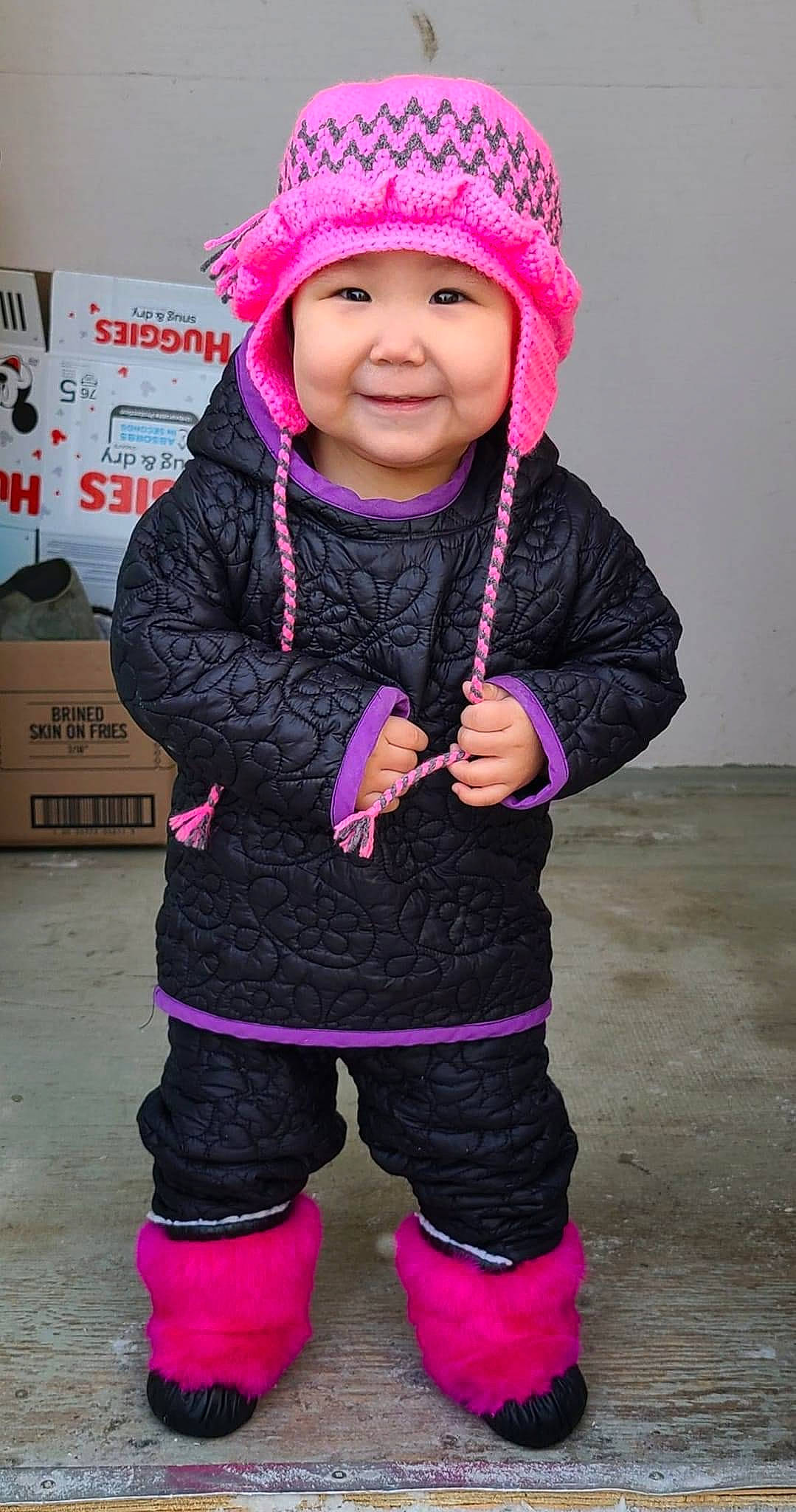 Katie is registered to the contest to win money with this photo: baby_toddler_clothing, cap, electric_blue, face, fashion_accessory, fun, happy, headwear, hood, human_body, jacket, joy, magenta, outerwear, person, personal_protective_equipment, pink, purple, sleeve, smile