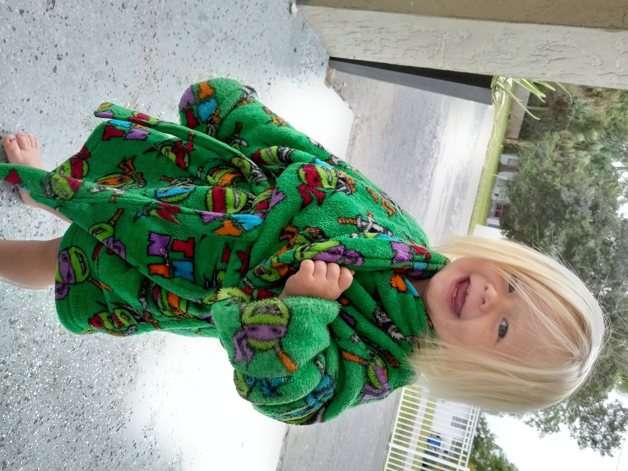 Aaliyah joined the competition — help win amazing prizes! art, child, event, fashion_accessory, fictional_character, foot, fun, grass, happy, holiday, human_leg, leisure, outerwear, pattern, person, plant, sitting, smile, sock, tree
