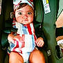 baby, child, car_seat, striped_clothing, headband, wide_eyes, curious, sitting, safety_harness, infant, indoors, person, cute, chubby_legs, small_hands, colorful, secure, seatbelt, portrait, young