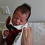 Ezyo participe au concours pour gagner de l'argent avec cette photo : newborn, baby, infant, hands, red_clothing, bow_tie, sleepy, portrait, indoor, person, cute, small, white_sleeves, face, head, skin, human, gentle, holding, resting