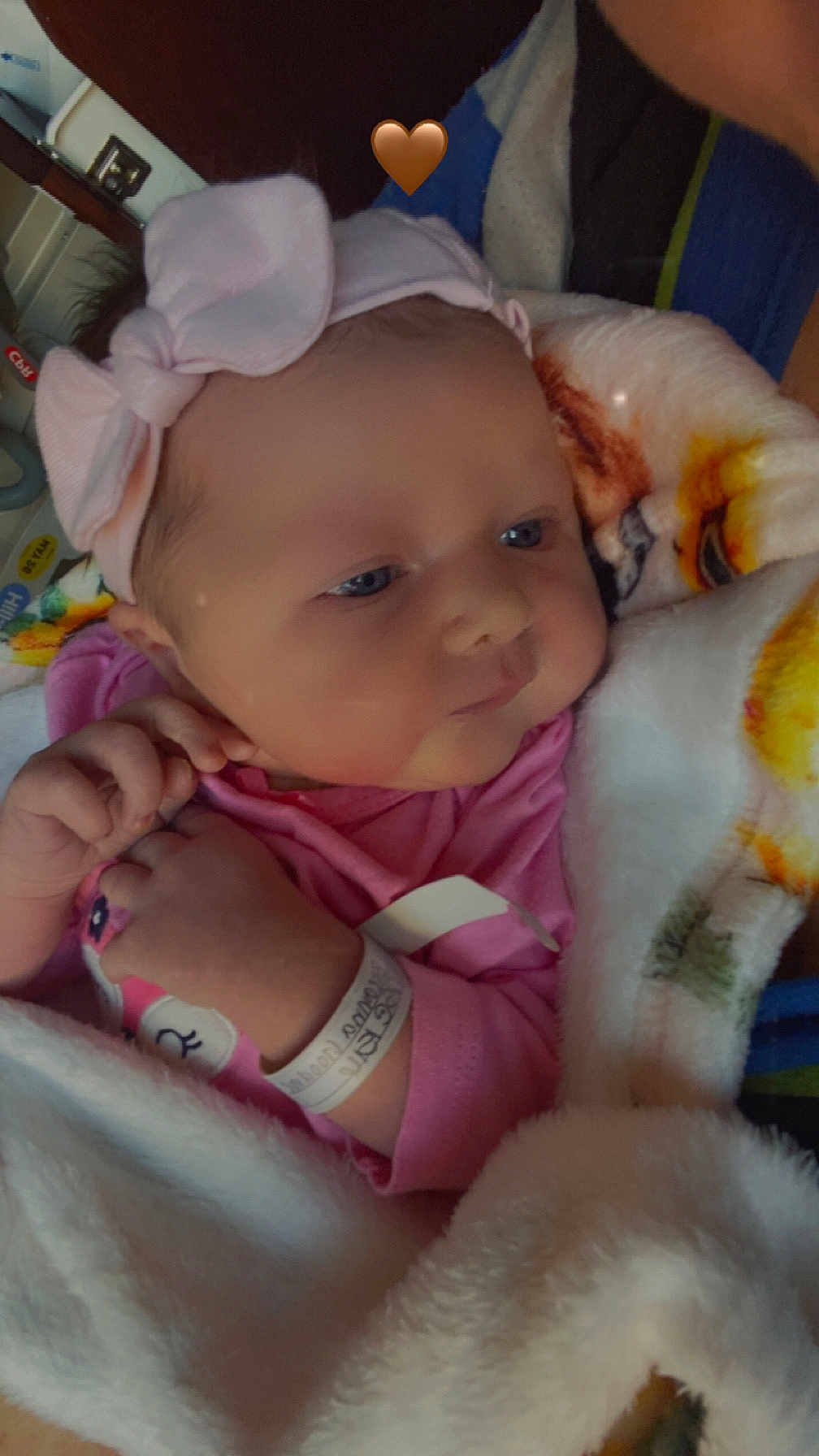 Brynleigh is registered to the contest to win money with this photo: baby, infant, blanket, pink_clothing, headband, bow, wristband, hospital, newborn, face, hand, blue_eyes, cute, cozy, closeup, portrait, soft_texture, indoor, person, sleepwear