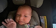 Brynleigh is registered to the contest to win money with this photo: baby, car, car_seat, child, child_safety, comfort, cute, face, hand, infant, interior, newborn, padding, person, safety, seatbelt, straps, warning_label, wearing_clothes, young_child