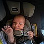 baby, car, car_seat, child, child_safety, comfort, cute, face, hand, infant, interior, newborn, padding, person, safety, seatbelt, straps, warning_label, wearing_clothes, young_child