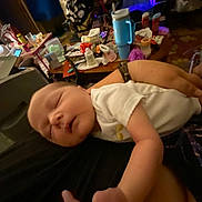 Brynleigh is registered to the contest to win money with this photo: newborn, baby, sleeping, infant, person, arm, hand, clothing, indoor, table, bottle, cup, furniture, adult, room, blanket, diaper, care, rest, comfort