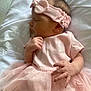 Brynleigh is registered to the contest to win money with this photo: baby, sleeping, pink_clothing, headband, tulle_skirt, infant, pillow, resting, peaceful, soft_light, closeup, cute, newborn, child, portrait, indoors, delicate, sleep, hand, face