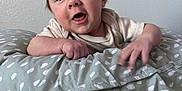 Jaxson joined the competition — help win amazing prizes! baby, infant, pillow, patterned_pillow, hand, face, expression, curious, soft_texture, blanket, bed, indoor, cute, child, young, skin, clothing, portrait, smiling, resting