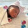 Miracle is registered to the contest to win money with this photo: newborn, baby, sleeping, blanket, hat, bow, hospital, bassinet, infant, peaceful, cute, wrapped, soft_light, portrait, closeup, child, resting, indoors, clothing, toddler