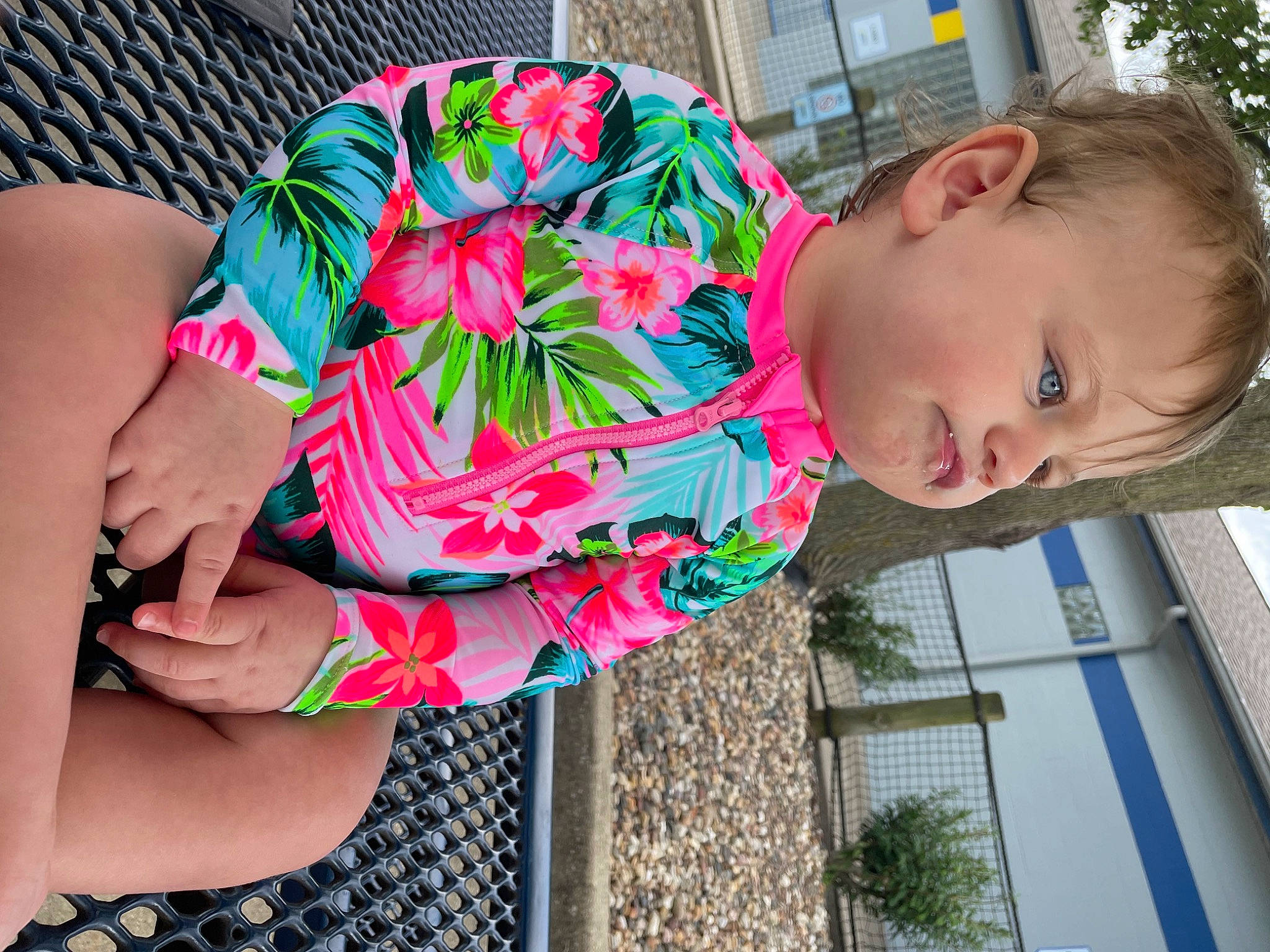 Tumaini is registered to the contest to win money with this photo: child, eyewear, facial_expression, fun, grass, happy, human_leg, knee, leisure, magenta, pattern, people, person, pink, plant, sleeve, smile, thigh, toddler, waist