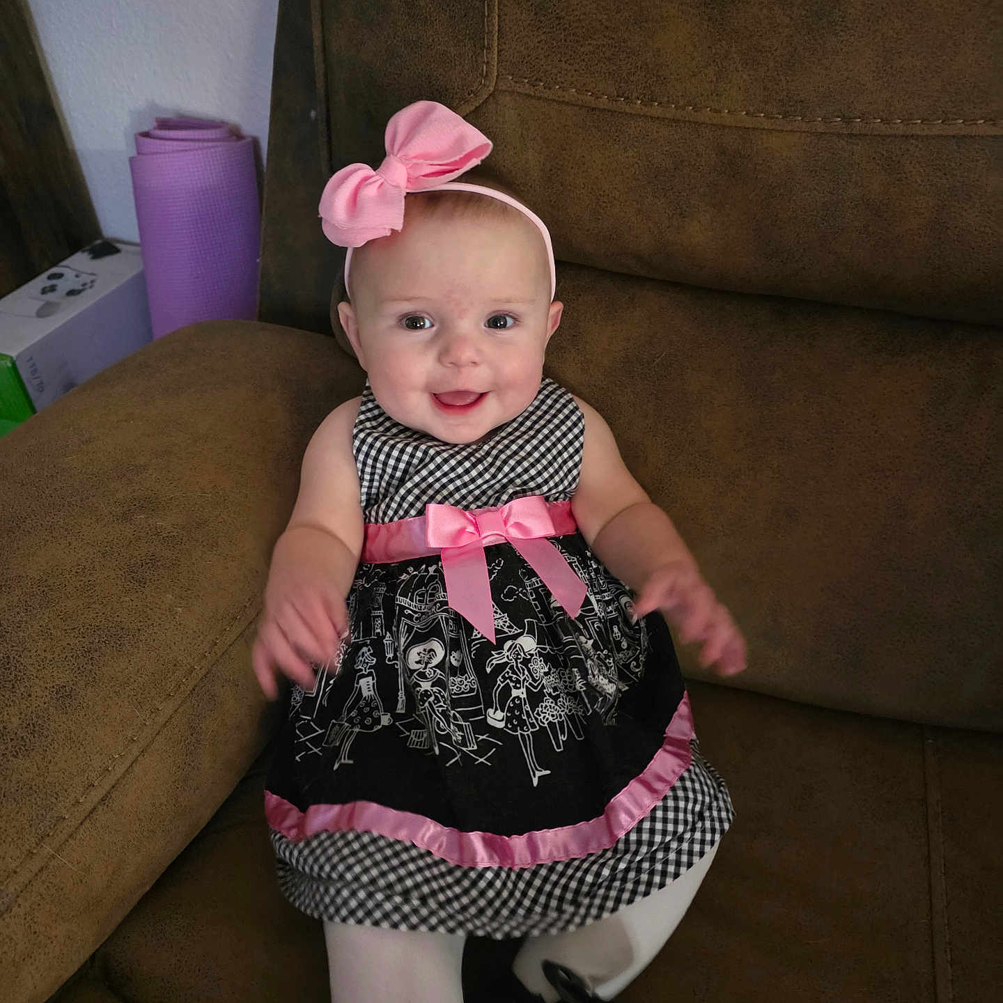 Lilley is registered to the contest to win money with this photo: baby, black_and_white, child, couch, cute, dress, furniture, girl, happy, head, headband, indoors, person, pink_bow, pink_ribbon, portrait, sitting, smiling, tights, young_child