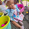 baby, children, toddler, infant, park, outdoor, basket, easter_eggs, plastic_eggs, colorful, chair, playground, headband, bow, braided_hair, beads, dress, sparkly_shoes, smiling, portrait