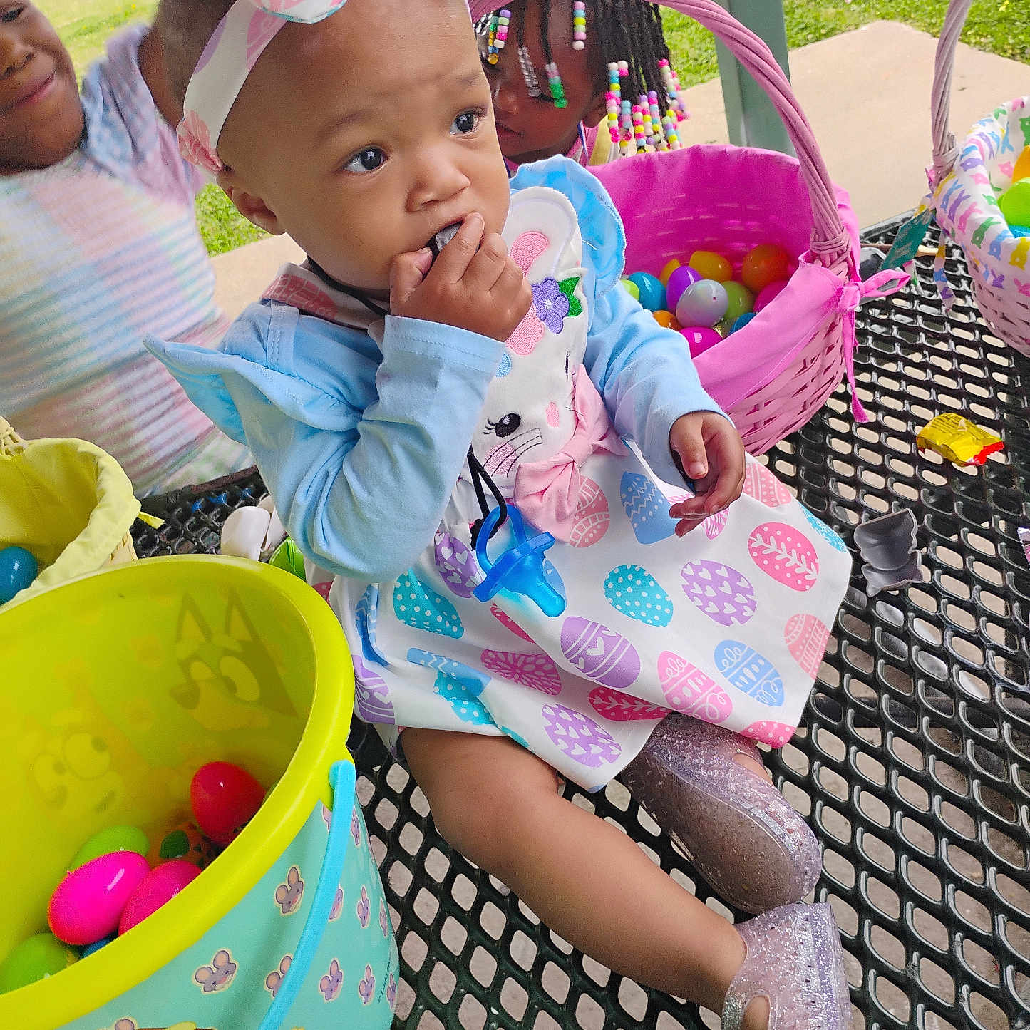 Lataylynn is registered to the contest to win money with this photo: baby, children, toddler, infant, park, outdoor, basket, easter_eggs, plastic_eggs, colorful, chair, playground, headband, bow, braided_hair, beads, dress, sparkly_shoes, smiling, portrait