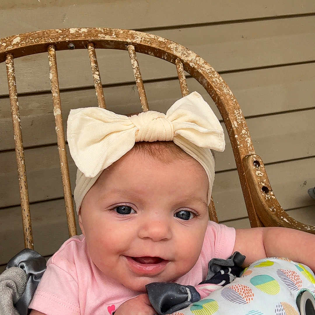 Johnnie is registered to the contest to win money with this photo: accessories, baby, bonnet, cap, clothing, couch, cushion, face, formalwear, furniture, happy, hat, head, homedecor, newborn, person, photography, portrait, sitting, tie