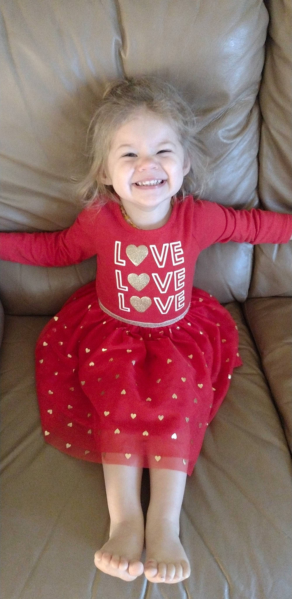 Laney is registered to the contest to win money with this photo: arm, baby_toddler_clothing, comfort, eye, face, hair, hairstyle, hand, head, human_body, joint, joy, leg, neck, organ, person, shoulder, skin, sleeve, smile