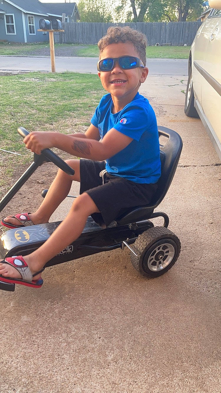 Aaron joined the competition — help win amazing prizes! automotive_tire, automotive_wheel_system, bicycle_accessory, cool, electric_blue, eyewear, fun, goggles, knee, person, riding_toy, rolling, shoe, shorts, smile, sneakers, sunglasses, tire, toddler, vehicle