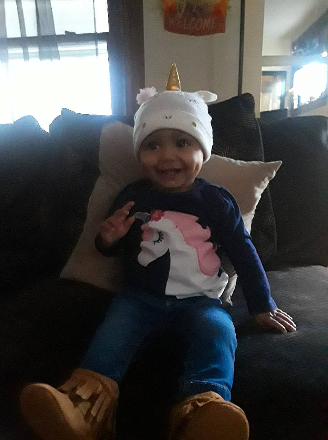 Kyliah is registered to the contest to win money with this photo: baby, beanie, cap, child, cool, ear, electronic_device, fun, gadget, happy, head, headgear, headwear, joy, leg, person, sitting, skin, sky, smile