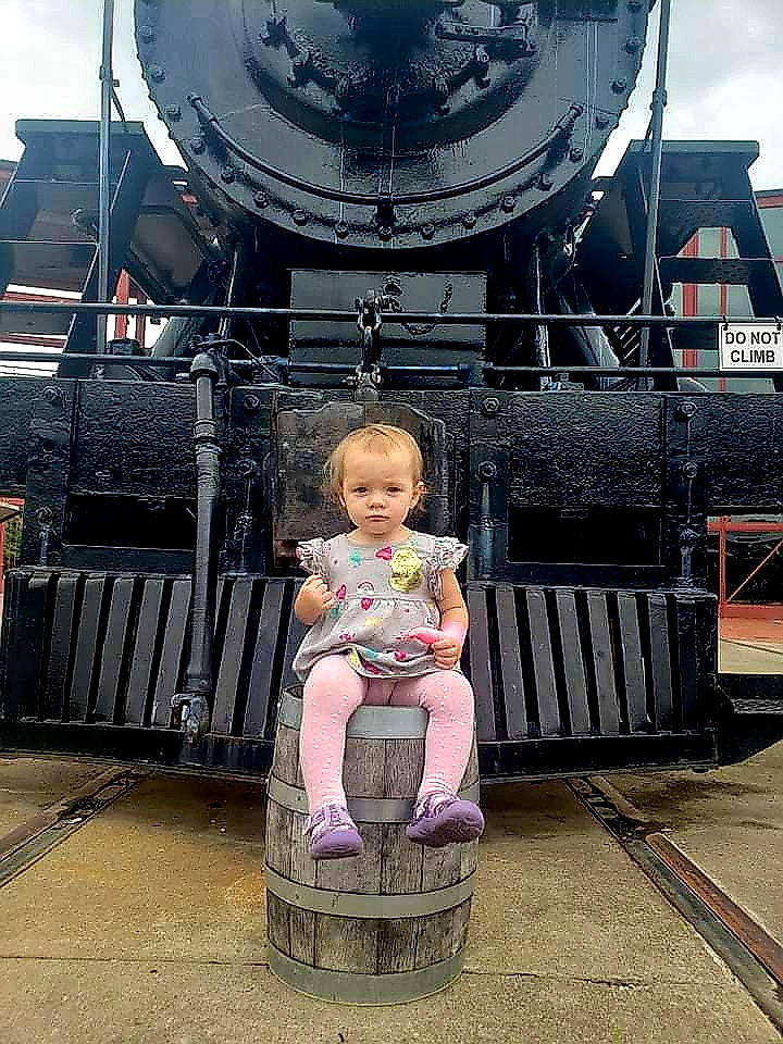 Susie joined the competition — help win amazing prizes! art, automotive_wheel_system, baby, baby_carriage, baby_products, bass_drum, black, cart, child, fun, leisure, metal, people, person, sitting, sky, snapshot, temple, toddler, tourism