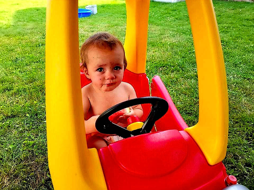 Susie is registered to the contest to win money with this photo: baby, baby_toddler_clothing, child, chute, city, fun, grass, happy, leisure, outdoor_play_equipment, people_in_nature, person, play, playground, recreation, riding_toy, shorts, swing, toddler, vehicle