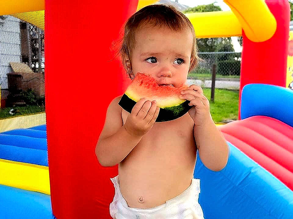 Susie joined the competition — help win amazing prizes! baby, baby_playing_with_toys, blue, child, fun, grass, green, happy, leisure, outdoor_play_equipment, people_in_nature, person, photograph, plant, play, recreation, red, snapshot, summer, toddler