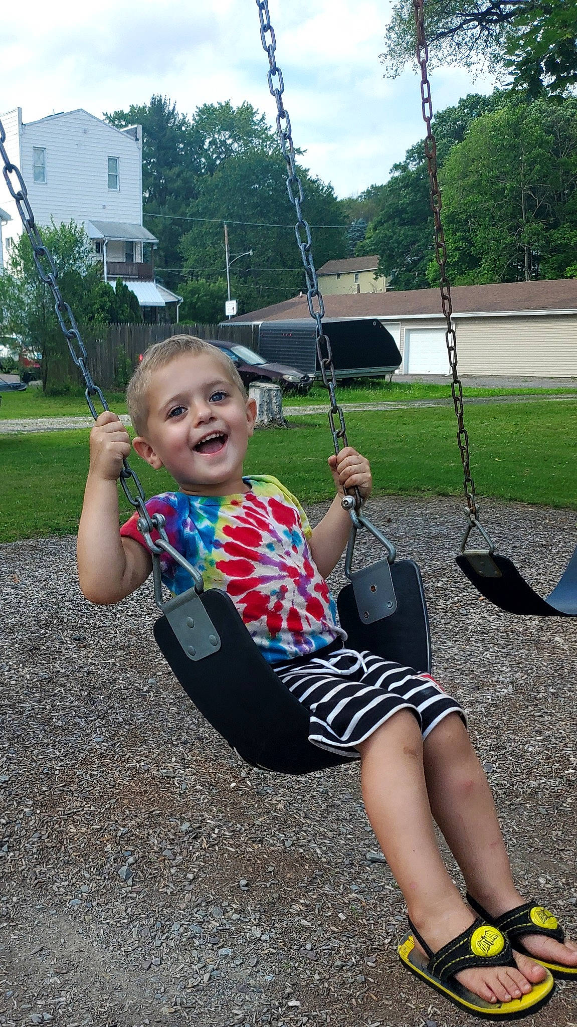 Deklan joined the competition — help win amazing prizes! baby_toddler_clothing, city, cool, fun, grass, happy, leg, leisure, outdoor_play_equipment, person, plant, play, playground, recreation, sky, smile, swing, t_shirt, thigh, toddler