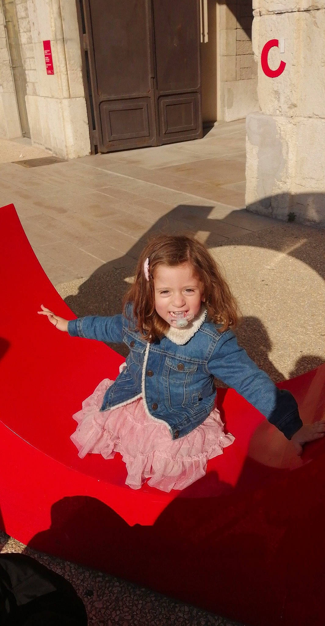 Amber participe au concours pour gagner de l'argent avec cette photo : child, door, eye, facial_expression, flash_photography, flooring, formal_wear, fun, hairstyle, happy, human_body, joy, leisure, magenta, person, pink, sitting, skin, sleeve, smile