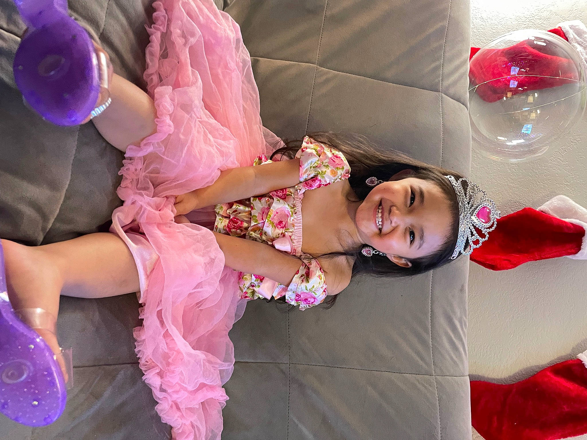 Jenesis is registered to the contest to win money with this photo: baby_toddler_clothing, child, dress, embellishment, event, fashion_accessory, fun, gesture, happy, human_leg, joy, leisure, magenta, pattern, person, pink, purple, sandal, skin, smile