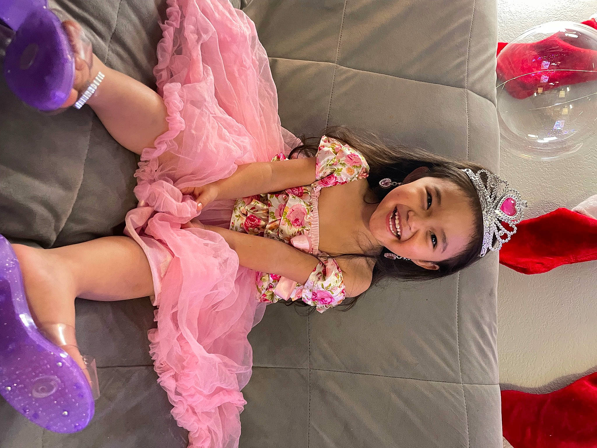 Jenesis is registered to the contest to win money with this photo: baby_toddler_clothing, child, comfort, dress, event, fashion_accessory, foot, fun, gesture, happy, human_leg, joy, leisure, magenta, peach, person, pink, sitting, skin, smile