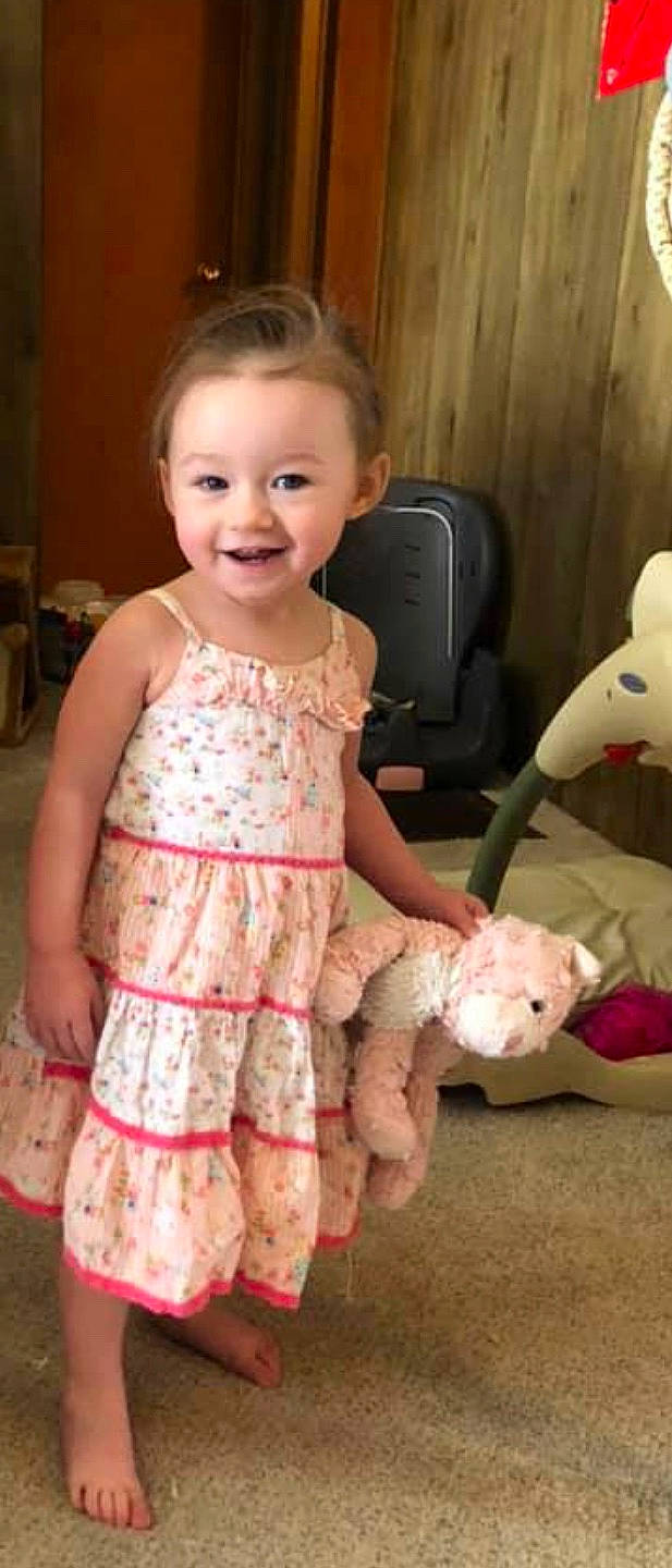 Kate is registered to the contest to win money with this photo: baby, cheek, child, dress, face, head, joy, nose, person, pink, play, product, sitting, skin, smile, teddy_bear, textile, toddler, toy