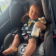 Ivory joined the competition — help win amazing prizes! baby, car_seat, sleeping, bottle, plush_toy, child, seatbelt, car_interior, foot, hand, clothing, head, face, window, daylight, relaxation, cute, infant, safety, rest