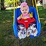 baby, child, swing, outdoor, grass, tree, headband, flower, playground, smiling, happy, colorful_clothing, pants, toy, seat, sunlight, nature, yard, rope, person
