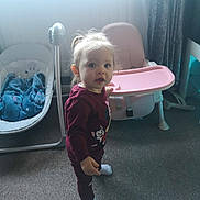 Zoé Lily joined the competition — help win amazing prizes! toddler, child, indoor, carpet, high_chair, baby_rocker, blanket, socks, curtain, window, daylight, furniture, person, clothing, floor, standing, young_child, face, hair, expression