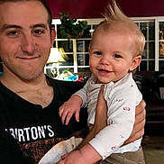 Maile joined the competition — help win amazing prizes! baby, casual, child, clothing, cute, family, furniture, hair, happy, holding, home, indoor, lamp, living_room, man, person, plant, portrait, smiling, window