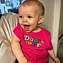 toddler, child, smiling, pink_shirt, indoor, happy, person, furniture, face, baby, sitting, armchair, home, light, casual_clothing, portrait, cute, young_child, expression, cheerful