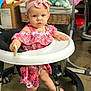 baby, child, walker, pink_dress, headband, snack, indoor, carpet, toy, furniture, person, foot, cute, expression, face, legs, standing, room, basket, colorful