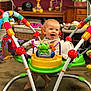 Maile Sue joined the competition — help win amazing prizes! baby, child, smiling, indoor, activity_jumper, toy, colorful, furniture, carpet, happy, person, foot, table, basket, playtime, home, cute, infant, room, fun