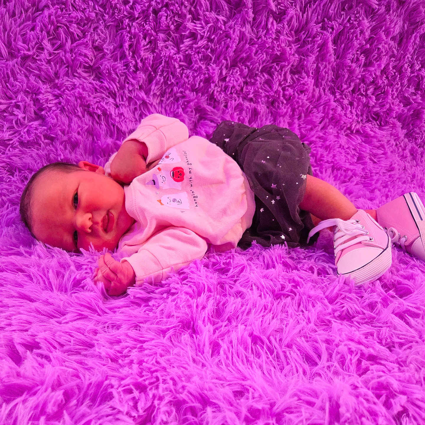 Abigail is registered to the contest to win money with this photo: baby, infant, child, portrait, lying_down, face, eyes_open, clothing, pink, magenta, rug, fluffy, shoes, sneakers, outdoor_style, fashion, cute, home, carpet, photography
