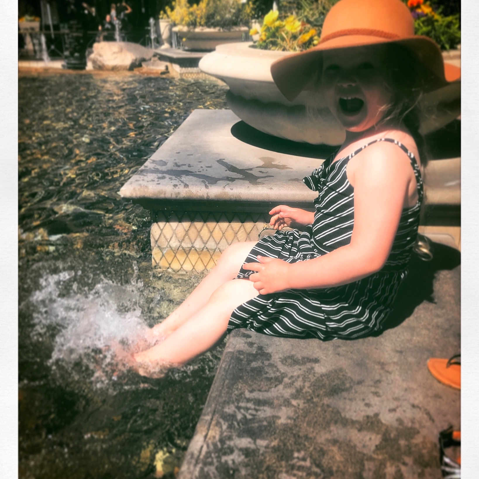 Memphis is registered to the contest to win money with this photo: beauty, child, child_model, fashion_accessory, hat, headgear, leaf, photograph, photography, rock, sitting, smile, snapshot, stock_photography, sun_hat, toddler, tree, vacation, water, water_feature