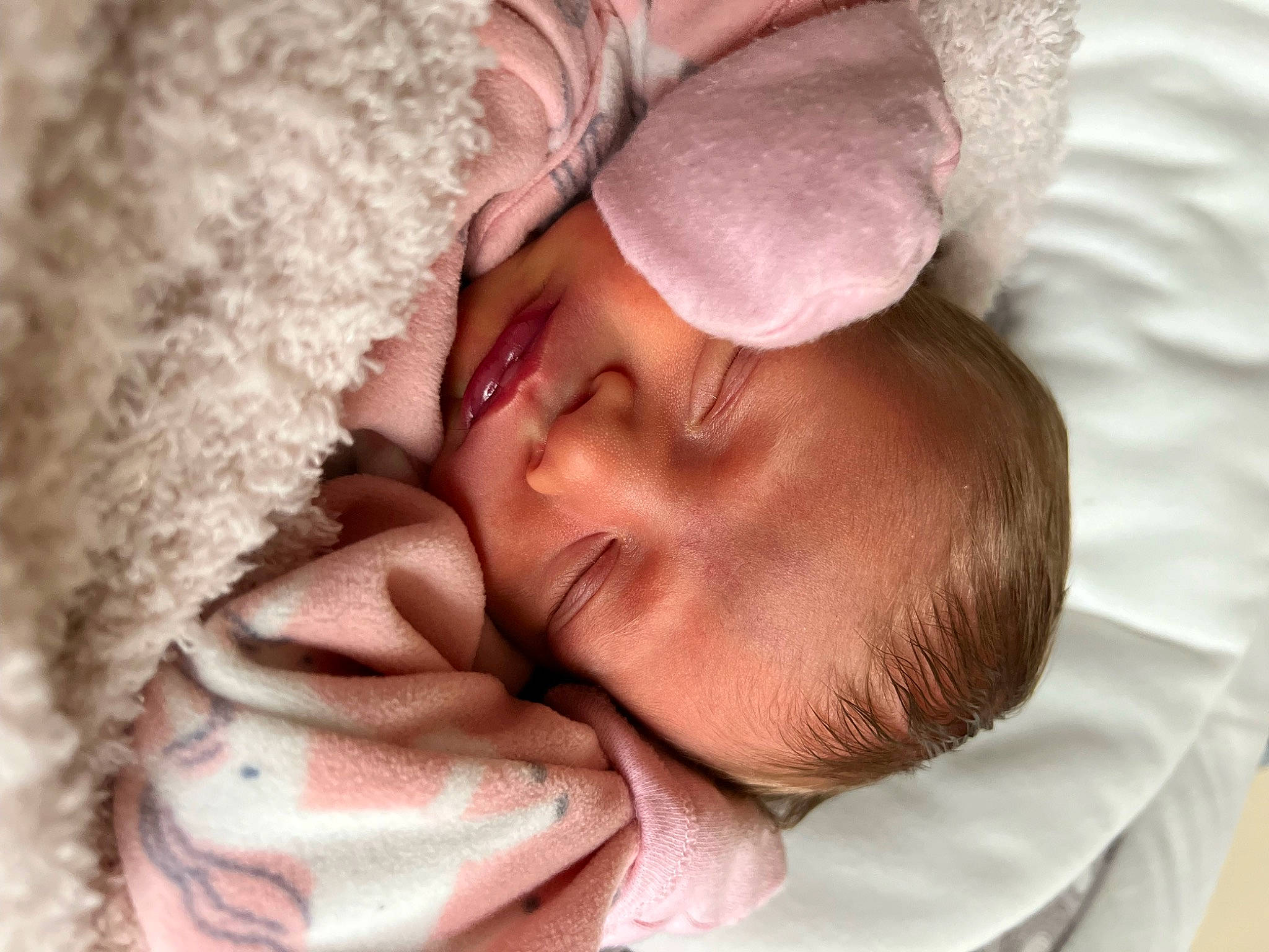 Mara is registered to the contest to win money with this photo: baby, baby_sleeping, bedtime, comfort, eye, eyelash, face, gesture, hair, hand, happy, head, human_body, interaction, linens, mouth, nose, person, skin, smile